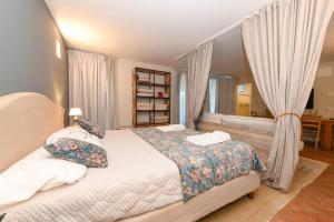 a bedroom with a bed with pillows and curtains at Villa Caterina in Salò +68 photos