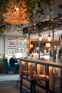 a bar in a restaurant with people sitting in chairs at The Peninsula Hotel in Vale