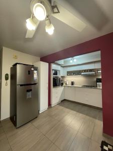 a kitchen with a stainless steel refrigerator in a room at Lysa Paraná in Paraná +25 photos