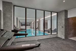 a room with a swimming pool and a house at Lindos Grand Resort & Spa - Adults Only in Lindos