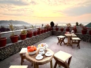 a balcony with tables and bowls of fruit on it at Kashmir Beautiful Villa in Srinagar