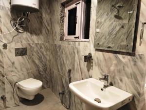a bathroom with a toilet and a sink at Kashmir Beautiful Villa in Srinagar +67 photos