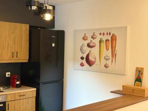 a kitchen with a picture of vegetables on the wall at the Lake View apartment in Mendrisio