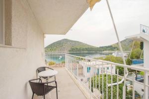 a balcony with a view of the water at Akrotopi Apartments & Studios in Tolo +33 photos