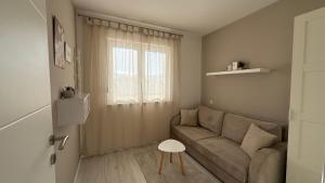 a living room with a couch and a window at Apartmani Berg in Pale