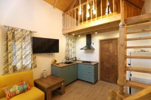 a kitchen with a couch and a sink in a room at Love Corner in Batumi