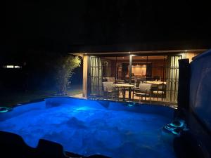 a house with a swimming pool at night at maison Clavita in Genk