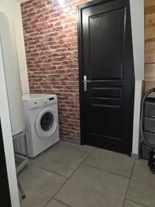 a door leading into a laundry room with a washing machine at Casa chic in Saint-Dizier +7 photos