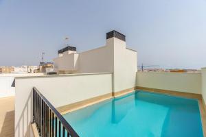 a swimming pool on the roof of a building at He Musica in Torrevieja
