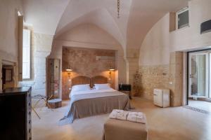 a bedroom with a bed in a large room at Palazzo Sant'Anna Lecce in Lecce