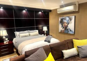 a bedroom with a large bed and a couch at Urban Oasis Gaborone "Secure Quiet Luxury in the City" near the CBD in Gaborone +14 photos