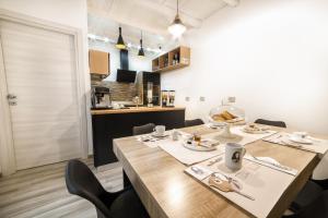a dining room with a large wooden table and chairs at Tzia Lillina B&B in Iglesias +47 photos