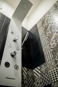 a room with a shower and a floor with tiles at Tzia Lillina B&B in Iglesias
