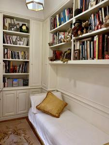 a room with a bed and shelves with books at Rooftop Garden in Bologna