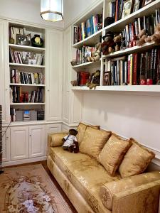 a couch in a living room with bookshelves at Rooftop Garden in Bologna