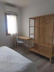 a bedroom with a desk and a book shelf at Ca' Rino - alloggio turistico in Vedelago