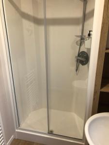a shower with a glass door in a bathroom at Dunes Escape in Lossiemouth +13 photos