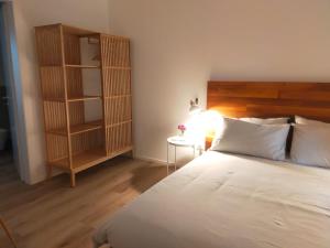 a bedroom with a bed and a book shelf at Ca' Rino - alloggio turistico in Vedelago