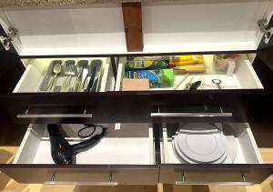 an open cabinet with a sink and a scissors at Urban Oasis Gaborone "Secure Quiet Luxury in the City" near the CBD in Gaborone
