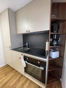 a small kitchen with a sink and a stove at Soltauer Bleibe in Soltau
