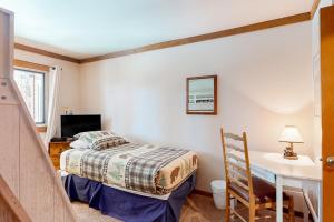 a small bedroom with a bed and a desk at Mountainback 47 in Mammoth Lakes +92 photos