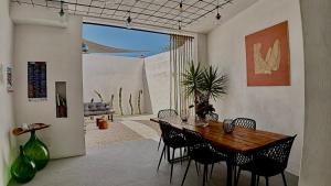 a dining room with a wooden table and chairs at META Affittacamere in Càbras +48 photos