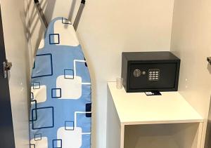 a room with a desk with a microwave next to a wall at Urban Oasis Gaborone "Secure Quiet Luxury in the City" near the CBD in Gaborone