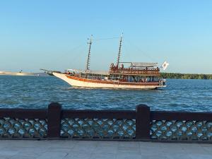 a boat with people on it sailing on the water at Green duplex cottage in Camocim in Camocim +24 photos