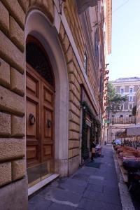 a building with a wooden door on a street at DEM Hotel in Rome