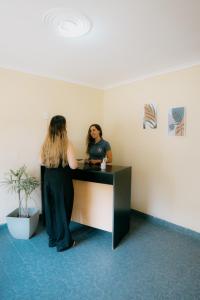 two women standing at a desk in an office at Las Cabañas in Colorado River