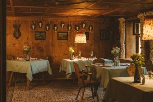 a dining room with two tables with white table cloth at Post Lech Arlberg in Lech am Arlberg