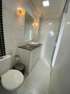 a bathroom with a toilet and a sink and a shower at Suíte Aconchegante in Belém