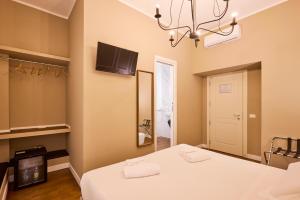 a bedroom with a bed and a mirror and a tv at DEM Hotel in Rome +26 photos