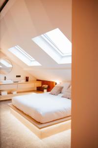 a bedroom with a bed with skylights in the ceiling at Héritage Collection - Suites in Verviers