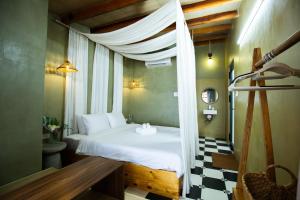 a bedroom with a bed with a canopy at First Love Room in Thưy Ðầm