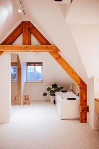 an attic room with wooden beams and a table at Héritage Collection - Suites in Verviers