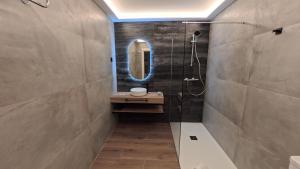 a bathroom with a shower and a sink and a mirror at Urdaibai Gernika Stages in Guernica y Luno
