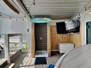 a room with a surfboard hanging from the ceiling at Tiki Tango Hideaway in Panama City Beach