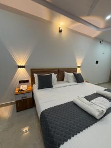 a bedroom with a large bed and a telephone at HOTEL FORTUNER Inn in Bangalore