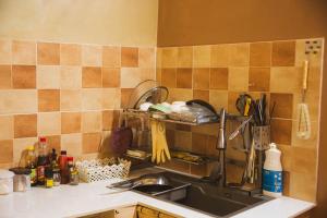 a kitchen with a sink and a counter top with utensils at First Love Room in Thưy Ðầm