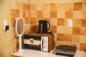 a microwave sitting on top of a counter with a blender at First Love Room in Thưy Ðầm