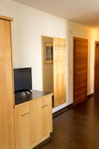a living room with a flat screen tv on a cabinet at Ferienwohnung Abraham in Nauders