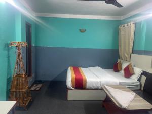 a bedroom with a bed and a blue wall at Parbat unique guest house in Kathmandu