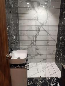 a bathroom with a toilet and a sink in it at Hotel P1 The Comfort Zone in Jalandhar
