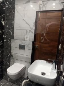 a bathroom with a white toilet and a sink at Hotel P1 The Comfort Zone in Jalandhar +1 photo