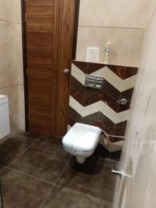 a bathroom with a white toilet in a room at Hotel P1 The Comfort Zone in Jalandhar