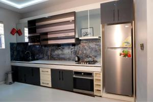 a kitchen with a stainless steel refrigerator at 2020 Apartment Guzape in Chini