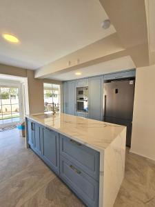 a kitchen with a large island with a counter top at Luxury 5BR Villa w Pool & Beach Access Ayvalık in Ayvalık