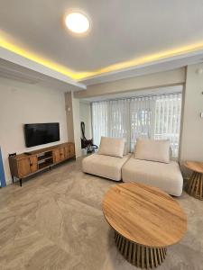 a living room with a couch and a table at Luxury 5BR Villa w Pool & Beach Access Ayvalık in Ayvalık