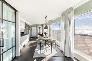a kitchen and dining room with a table and chairs at Horizon Suite at Sea in Vlissingen